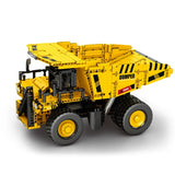 Camion minier à benne basculante en briques jaunes et noires, vue trois-quarts